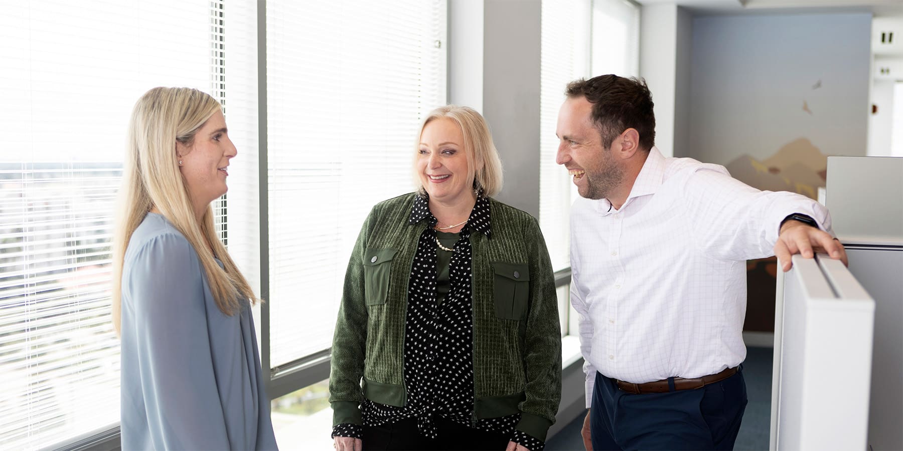 Advisors and leadership chatting in open office area