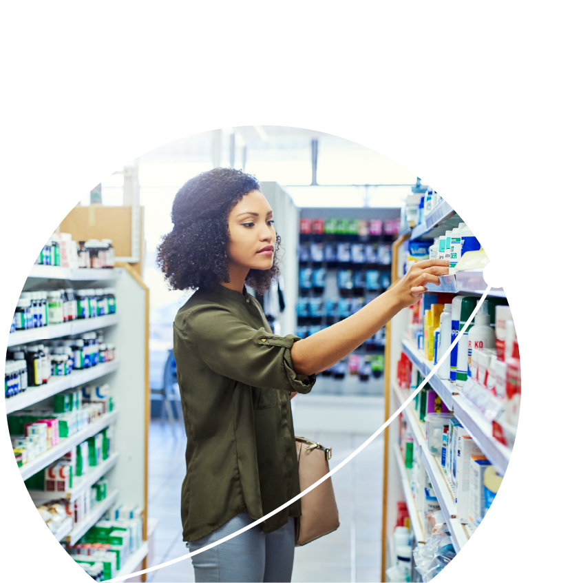 Woman standing in pharmacy aisle looking at options