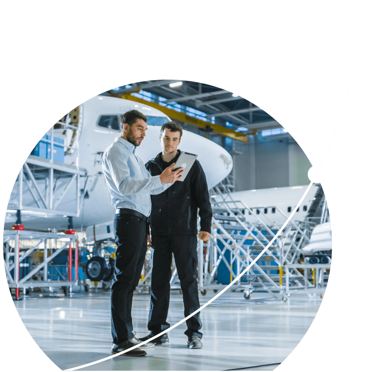 Aircraft Maintenance Worker and Engineer having Conversation. Holding Tablet.