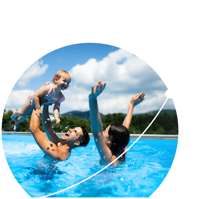 A happy couple playing with their child in the pool