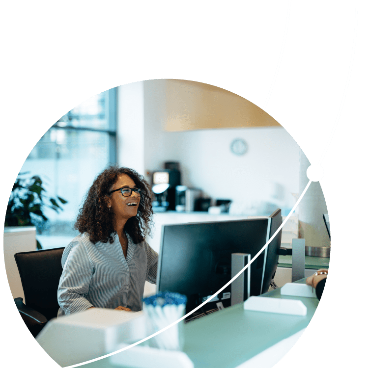 Receptionist assisting a woman standing at front desk. Woman standing at the reception talking with a friendly receptionist behind the desk of municipality office.