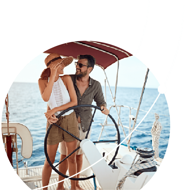 A couple on a sail boat at the wheel