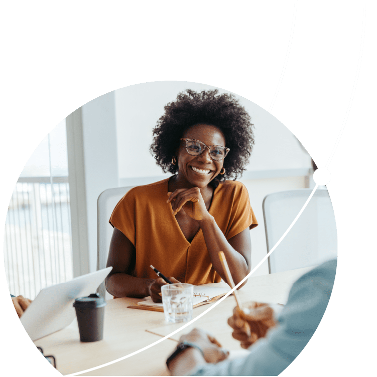 Black business woman leading a group of colleagues in a modern office boardroom