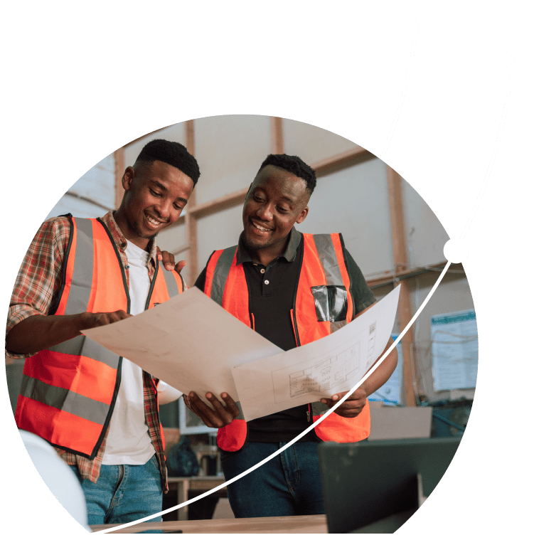 African American colleagues in safety vests review designs in carpentry warehouse