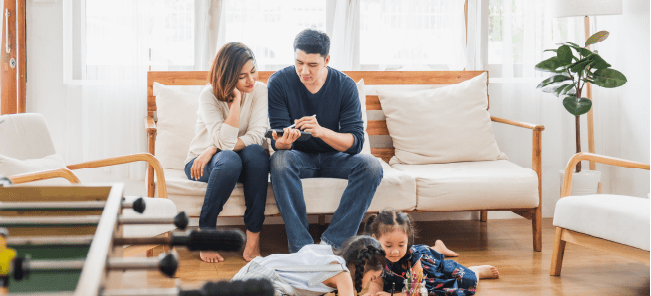 Asian family with cute daughters painting art in living room at home