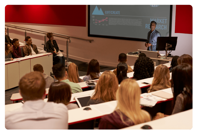 Young adult students at a university lecture, back view