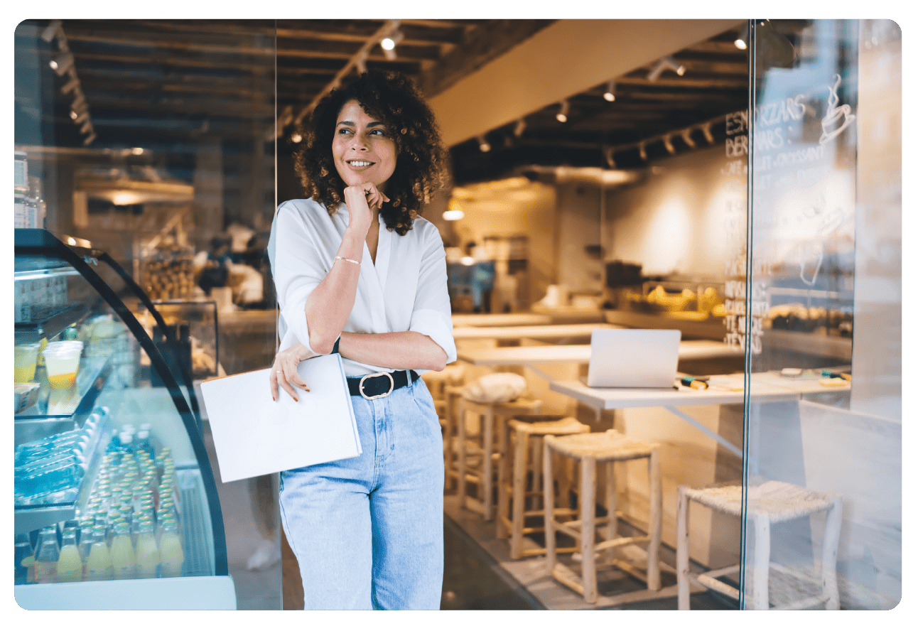 Women business owner standing outside of restaurant-style business