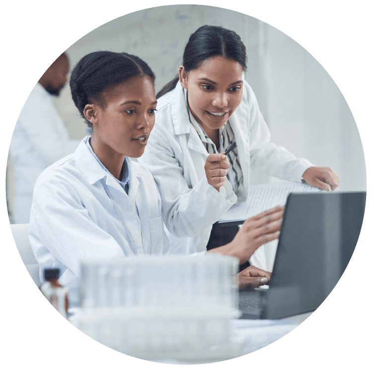 Improving lives one collaboration at a time. Shot of two young scientists using a laptop in a laboratory.