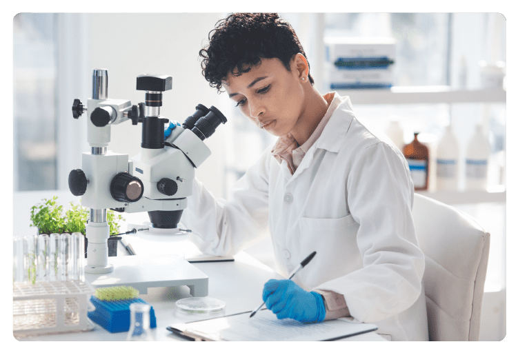 What she finds she records. Cropped shot of an attractive young female scientist making notes while working with a microscope and plants in a laboratory.