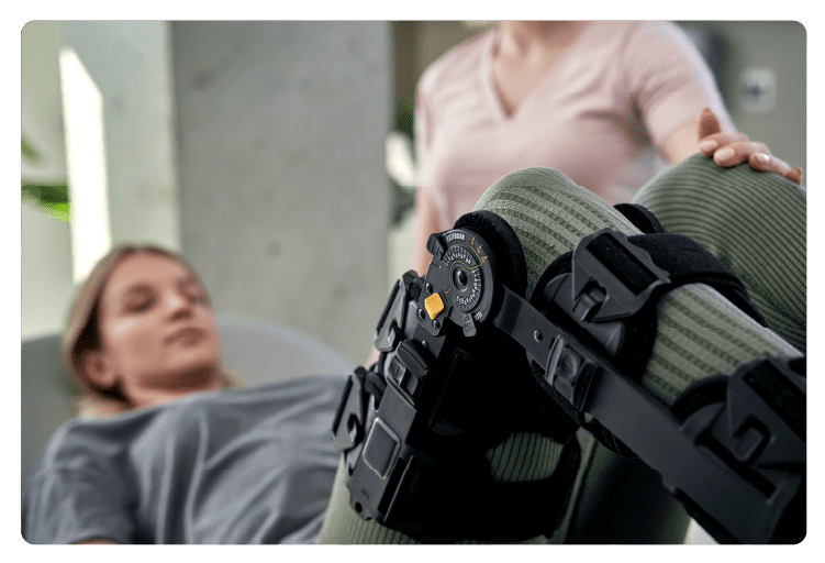 Close up of young woman with orthosis working with physical therapist